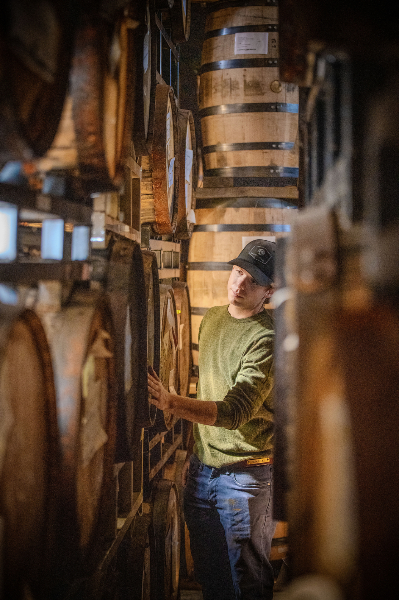 Murray David Harwich III inspecting barrels in the rickhouse